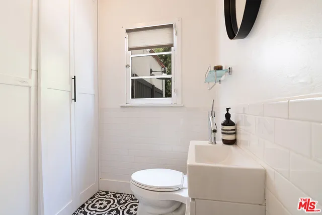 a bedroom with a bed window and couch