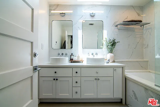 a view of a patio with couches table and chairs and potted plants