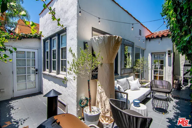 a front view of a house with outdoor seating