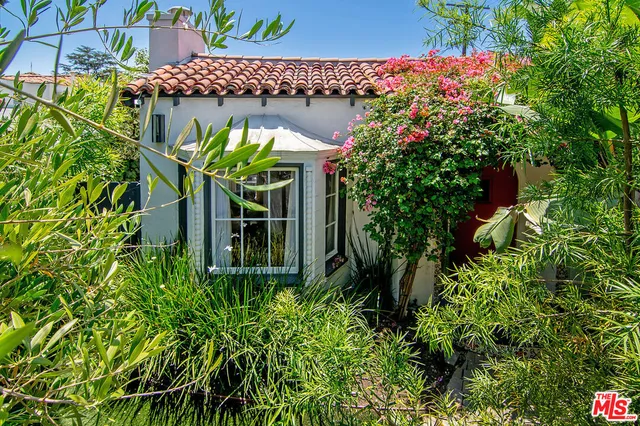 a picture of flowers in front of a house