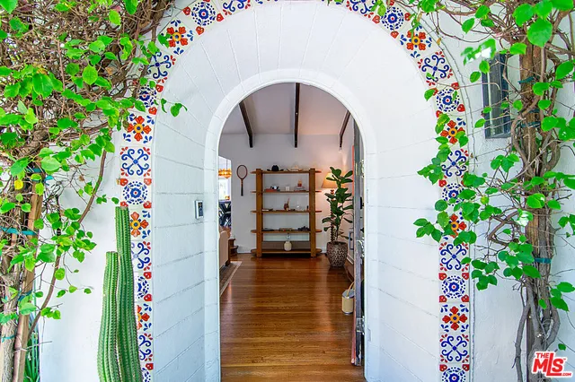 a living room with furniture fireplace and wooden floor