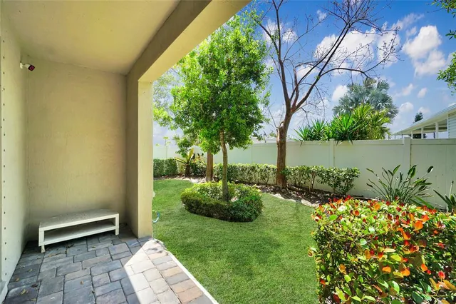 a view of a backyard with potted plants and a fountain