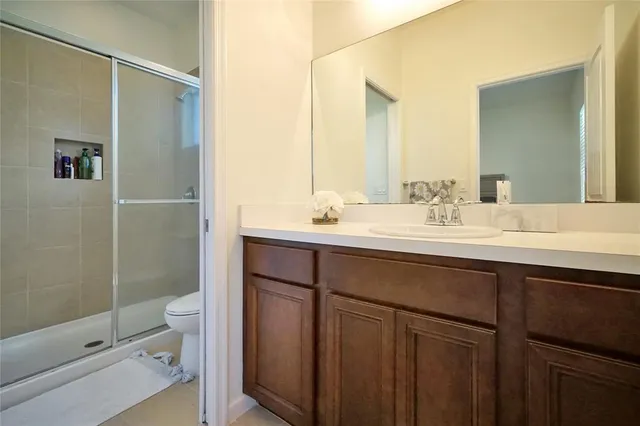a bathroom with a double vanity sink toilet and shower