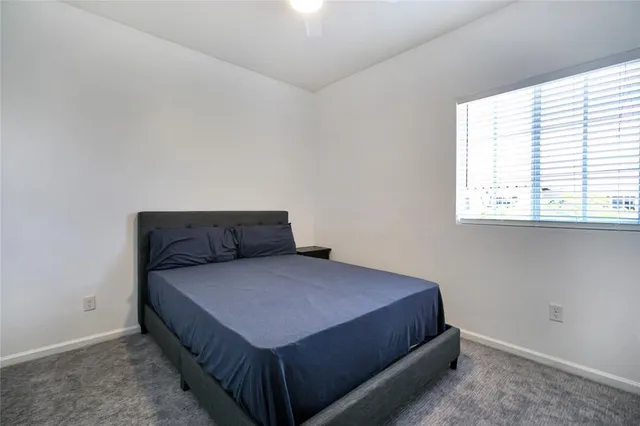 a bedroom with a bed and window