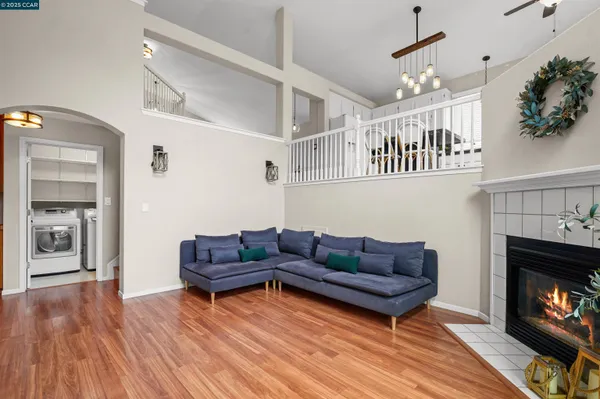a living room with furniture a fireplace and wooden floor