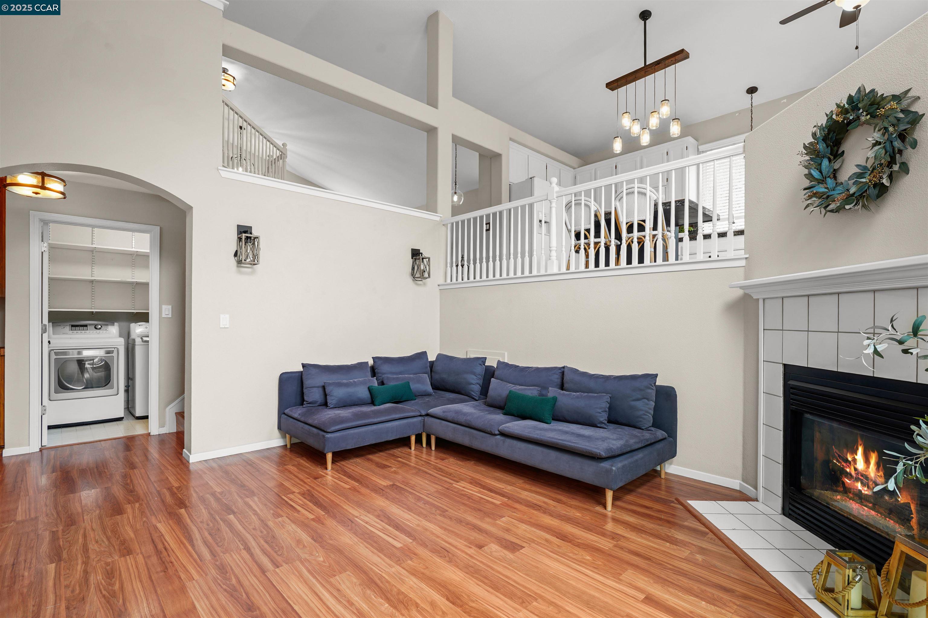 2063 Bluerock Court Concord, CA 94521 - Photo 12 of 38 a living room with furniture a fireplace and wooden floor
