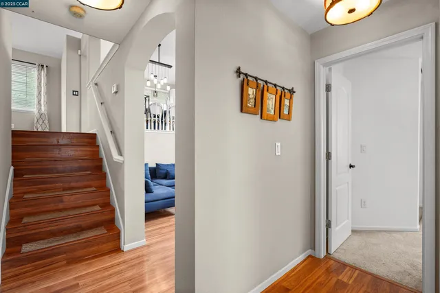 a view of a hallway with wooden floor and entryway
