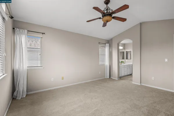 a view of a livingroom with a ceiling fan a ceiling fan and a window