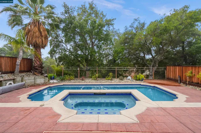 a view of a house with swimming pool and sitting area