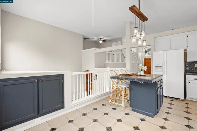 a kitchen with stainless steel appliances a table and chairs in it