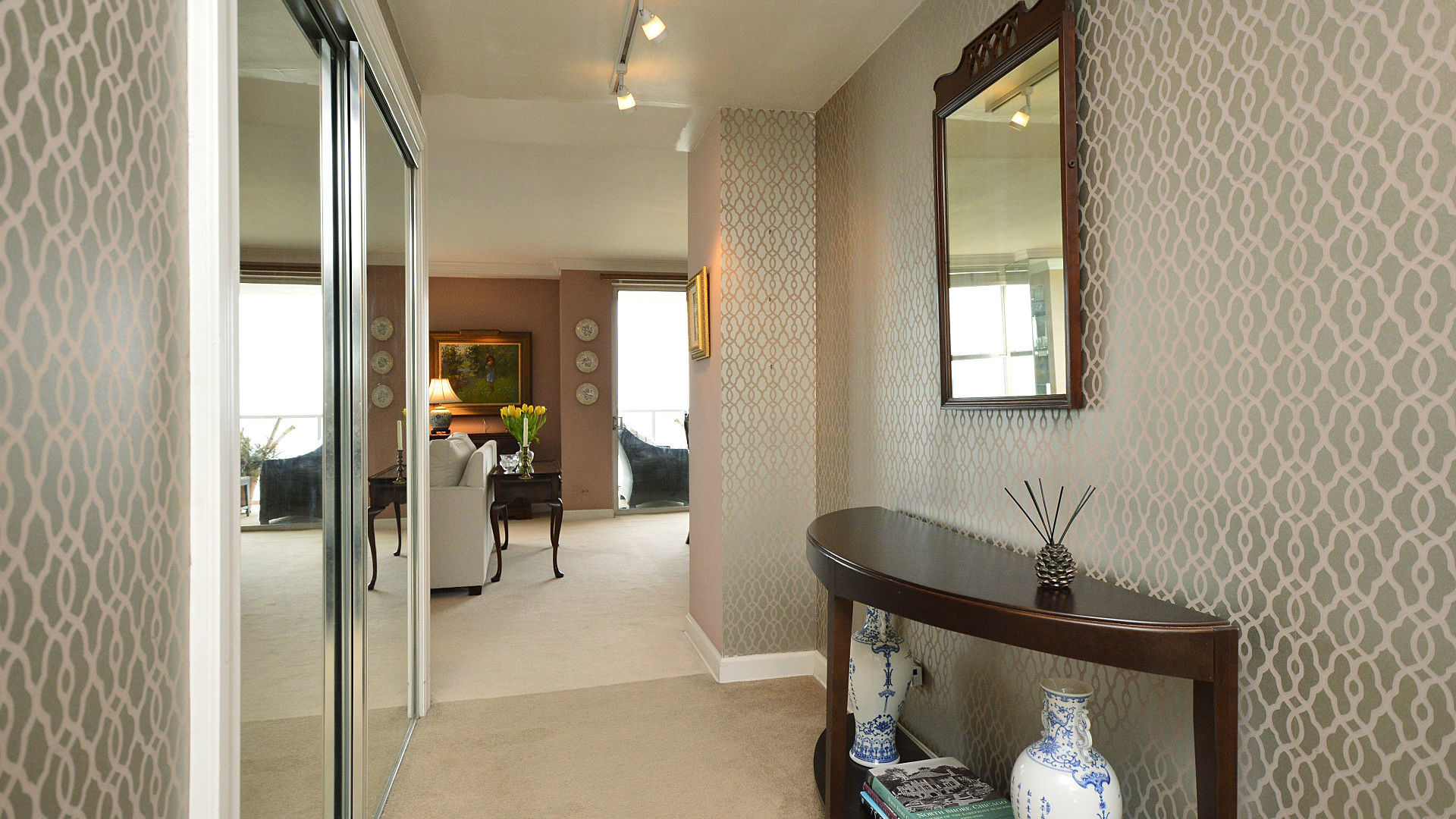 1616 Sheridan Road, Unit 7A Wilmette, IL 60091 - Photo 3 of 22 a view of a hallway with a livingroom and a mirror
