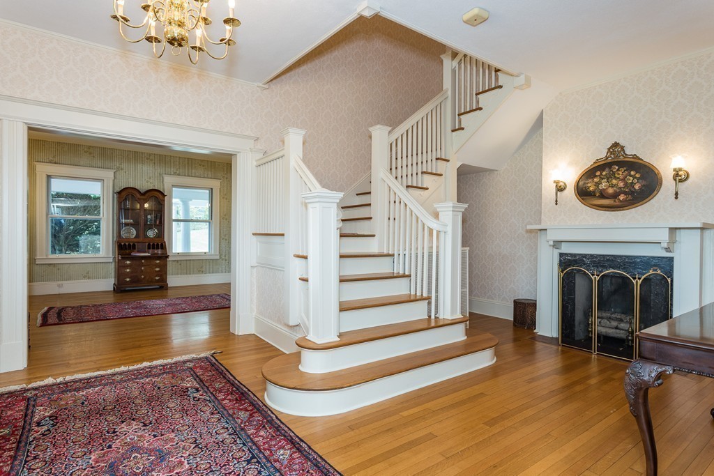 58 S Road Hampden, MA 01036 - Photo 3 of 28 a view of a livingroom with a fireplace wooden floor and a chandelier