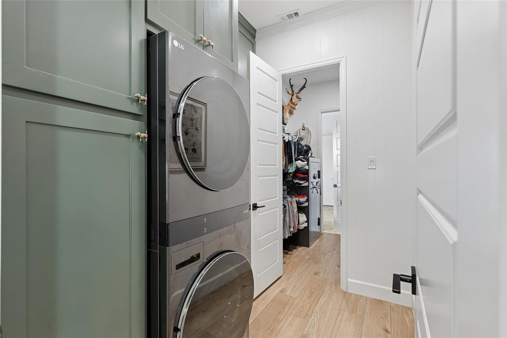 582 Broadleaf Way Haslet, TX 76052 - Photo 21 of 40 Laundry opens directly into primary closet. Floor to ceiling cabinets, folding table. Opposite door opens to the pantry, kitchen area.
