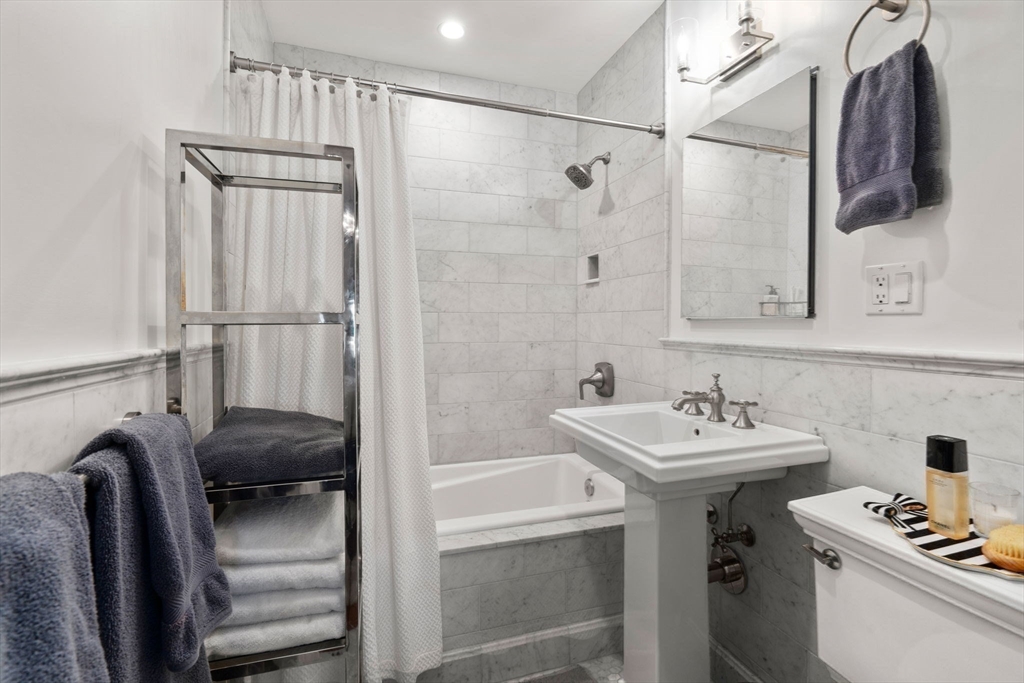 58 Temple Street, Unit 3 Boston, MA 02114 - Photo 12 of 17 a bathroom with a sink and a mirror