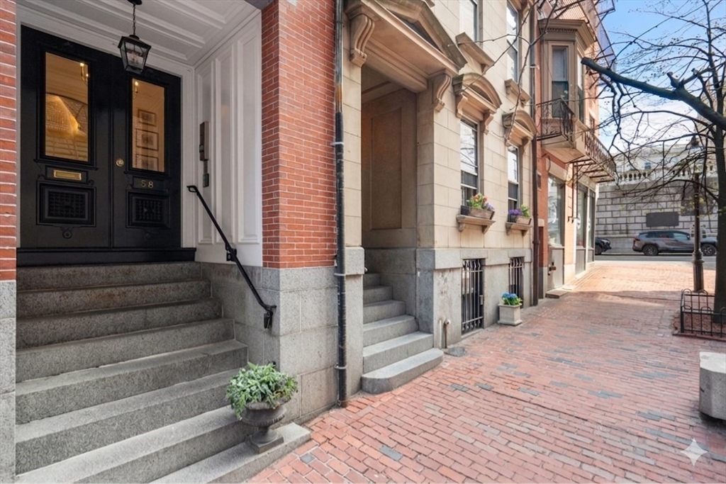 58 Temple Street, Unit 3 Boston, MA 02114 - Photo 15 of 17 a view of a building with stairs and bench