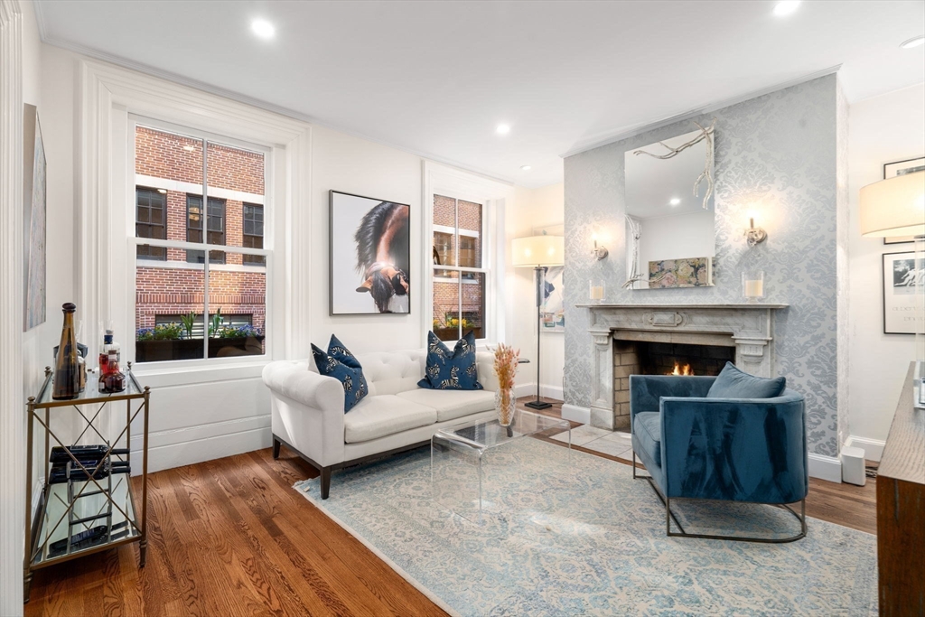 58 Temple Street, Unit 3 Boston, MA 02114 - Photo 2 of 17 a living room with furniture and a fireplace