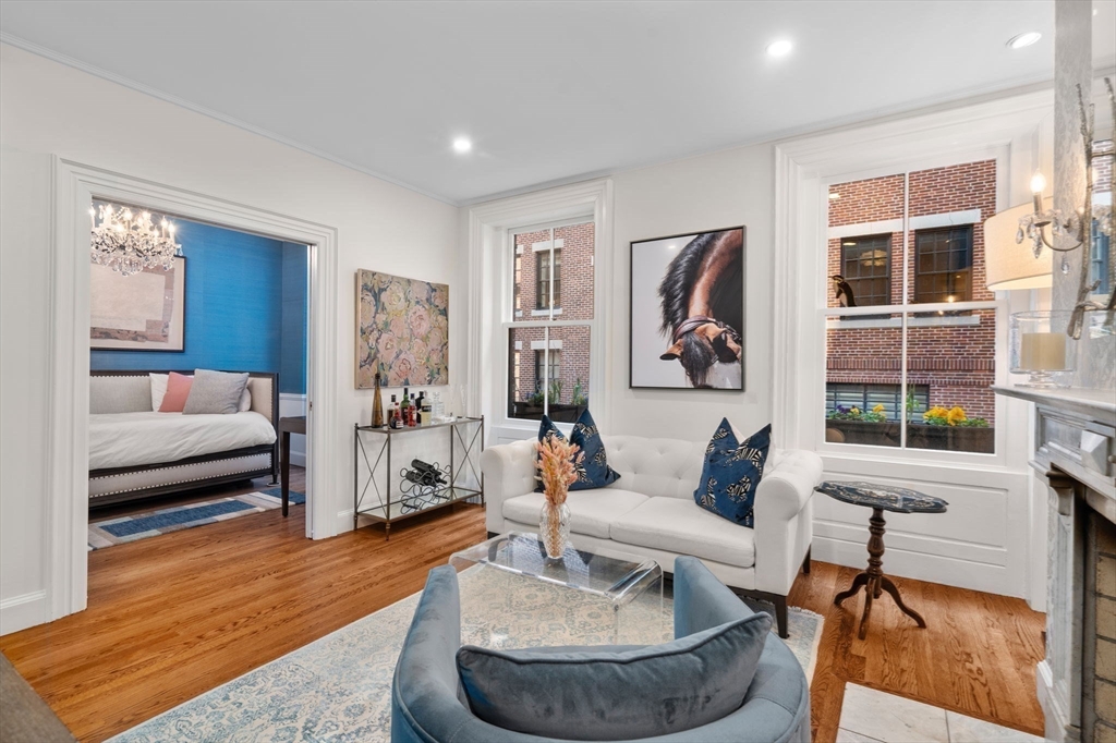 58 Temple Street, Unit 3 Boston, MA 02114 - Photo 3 of 17 a living room with fireplace furniture and a wooden floor