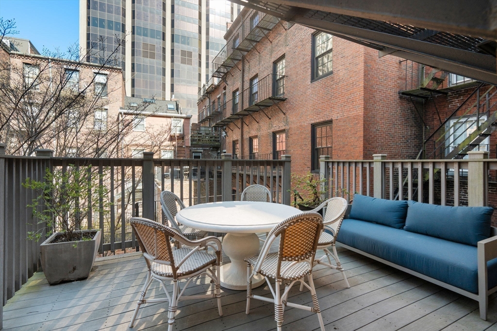 58 Temple Street, Unit 3 Boston, MA 02114 - Photo 9 of 17 a view of a chairs and table on the roof deck