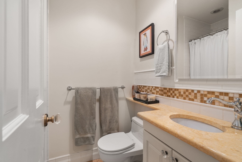 58 Temple Street, Unit 3 Boston, MA 02114 - Photo 10 of 17 a bathroom with a granite countertop sink a toilet and a shower