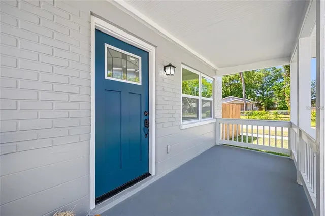 a view of a porch with wooden floor and a yard