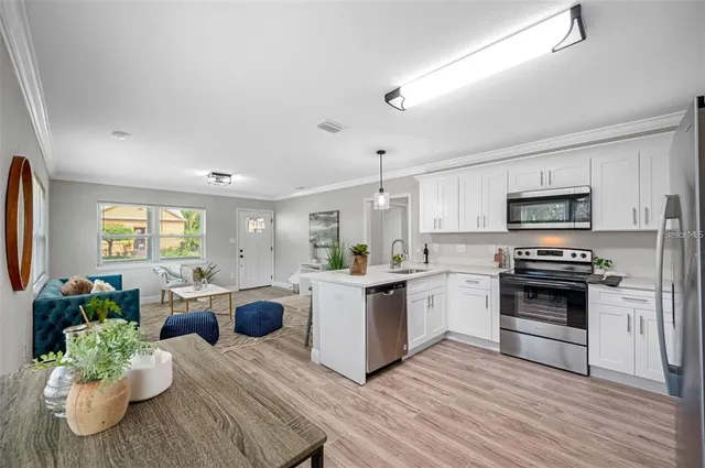 a kitchen with stove and cabinets