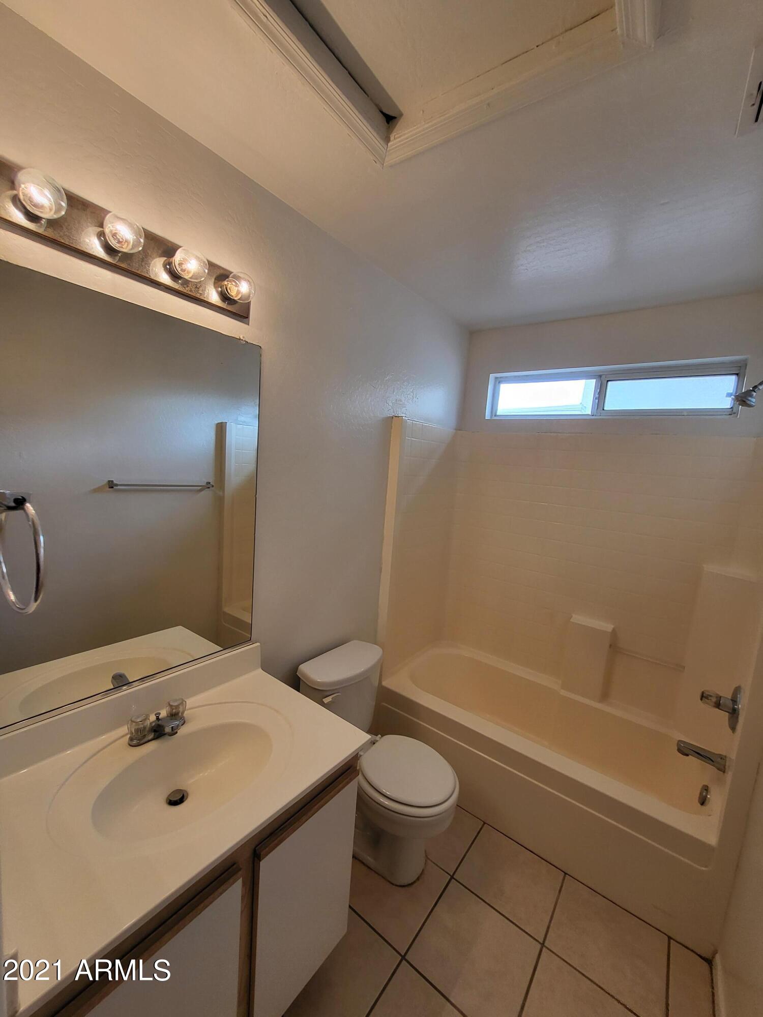 11929 West Larkspur Road El Mirage, AZ 85335 - Photo 9 of 12 a bathroom with a sink a toilet and shower