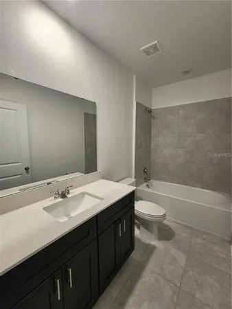 a spacious bathroom with a double vanity sink and mirror