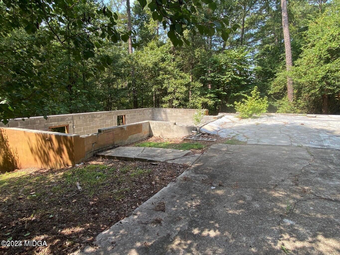 216 River Hills Ridge Road Macon, GA 31211 - Photo 2 of 6 a view of a yard with large trees