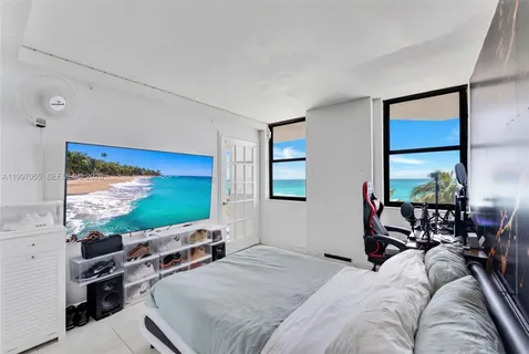 a bedroom with furniture and a flat screen tv