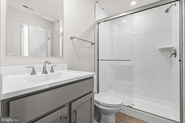 a bedroom with a bed and a potted plant