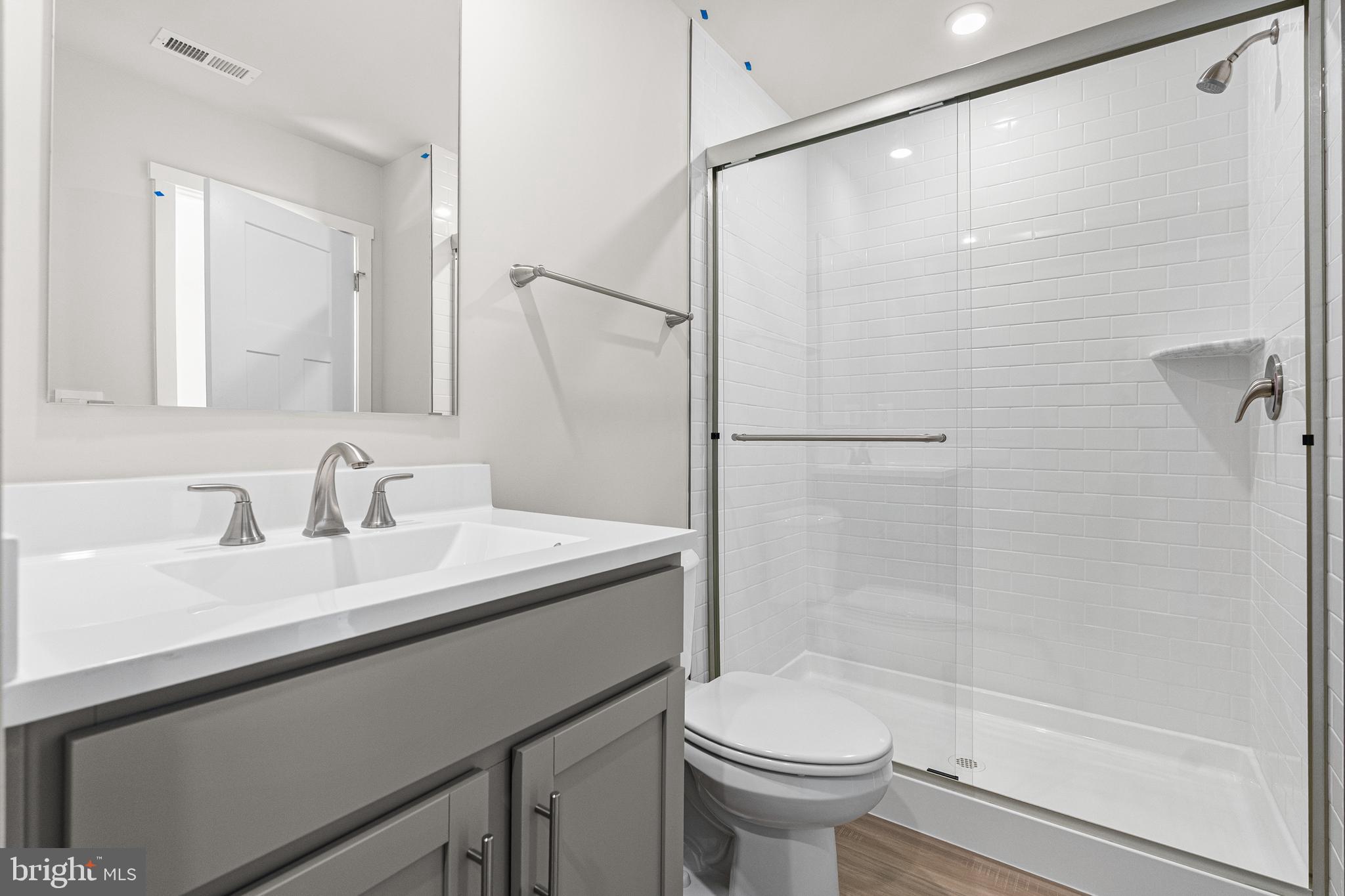 2233 Huntwell W Avenue Ranson, WV 25438 - Photo 12 of 20 a bathroom with a sink a toilet and shower