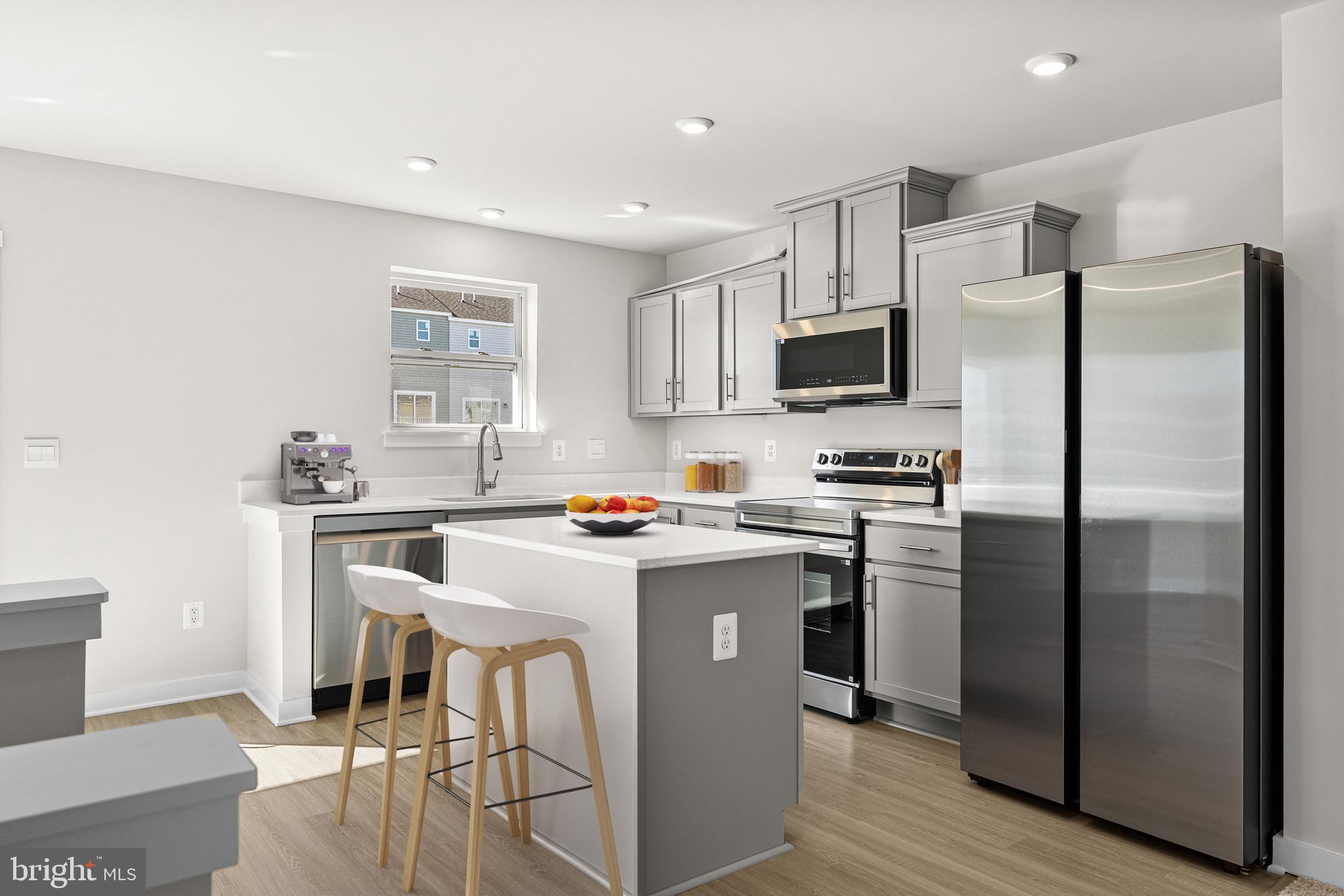 2233 Huntwell W Avenue Ranson, WV 25438 - Photo 14 of 20 a kitchen with stainless steel appliances a refrigerator stove microwave and sink