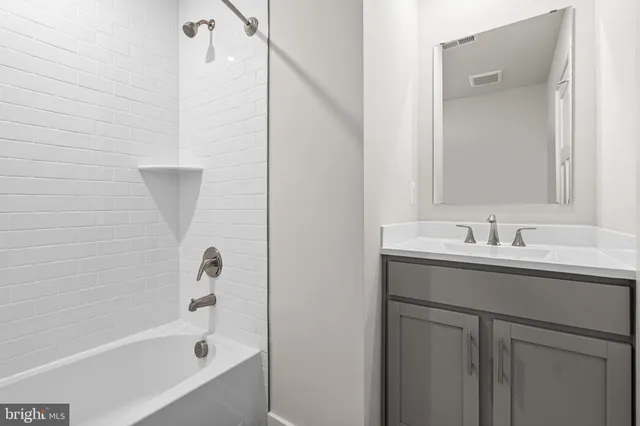 a bathroom with a sink and mirror