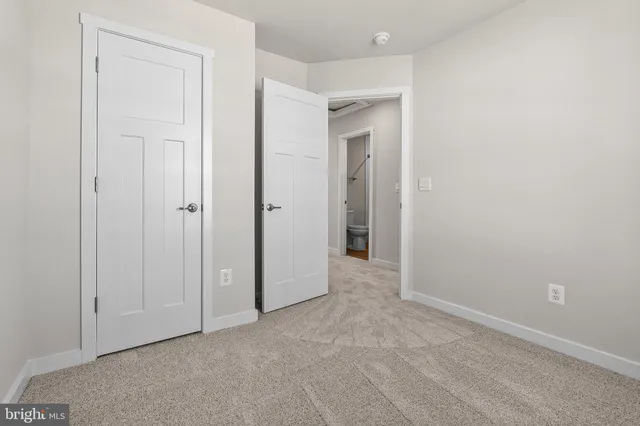 a bedroom with a bed and a lamp