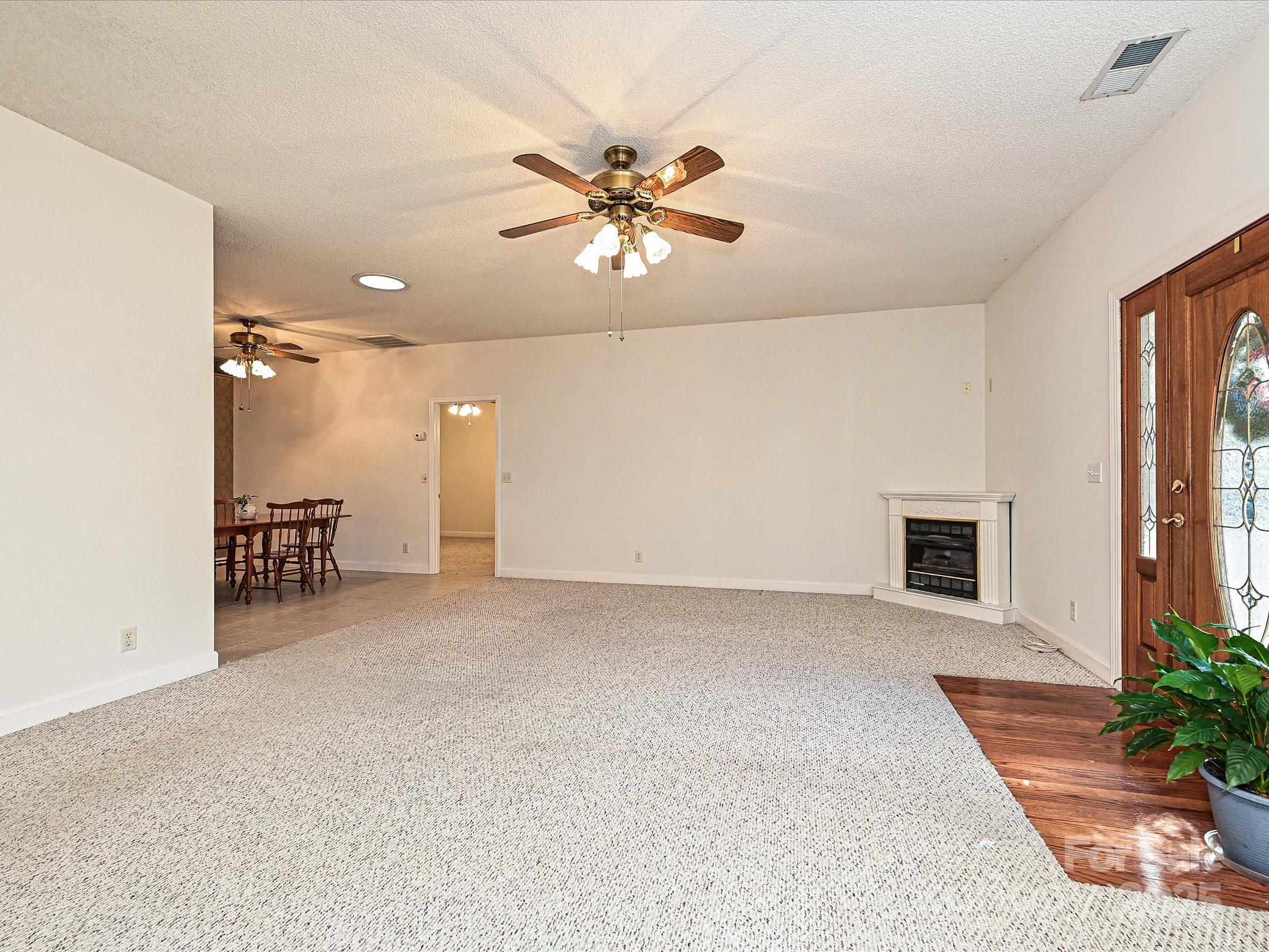 25040 Timberlake Drive Tega Cay, SC 29708 - Photo 8 of 40 a view of a livingroom with a ceiling fan and window