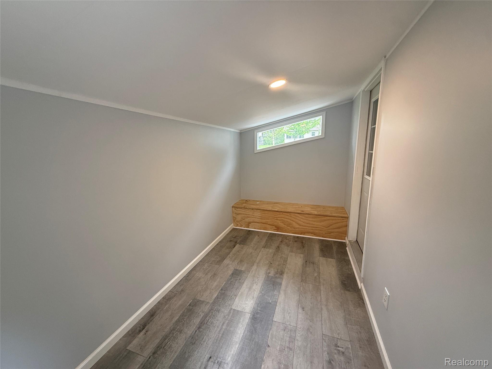 7149-7163 Burpee Road Grand Blanc, MI 48439 - Photo 35 of 72 Spare room with wood finished floors, crown molding, and recessed lighting