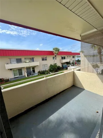 a view of a house with a yard porch and sitting area