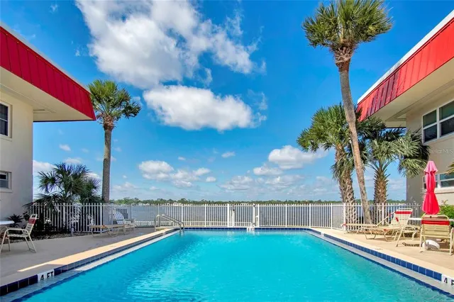 a view of a backyard with swimming pool