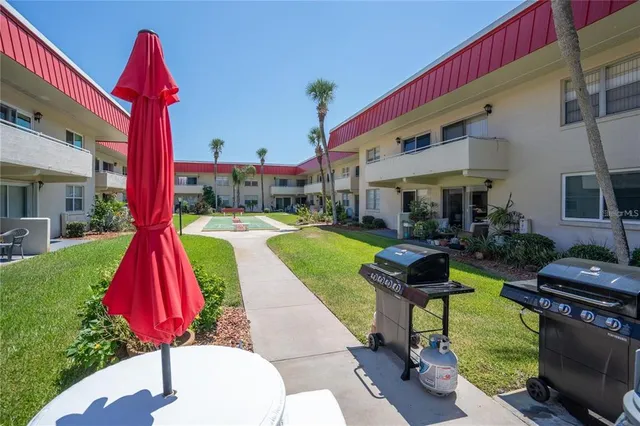 a room with pool table and large windows