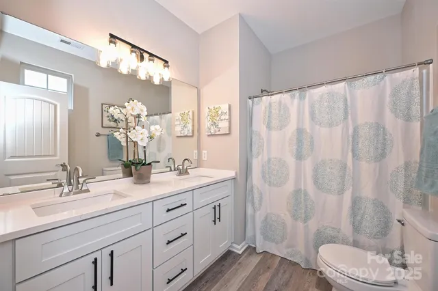 a bathroom with a double vanity sink mirror double and shower