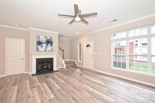 a view of an empty room with a fireplace and a window