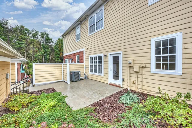 a view of a house with a yard and sitting area