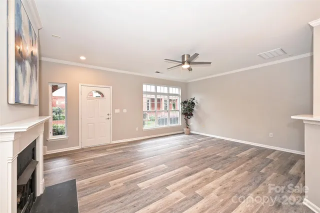 a view of an empty room with a fireplace and a window