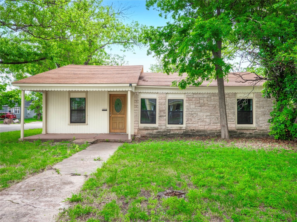 a front view of a house with a garden