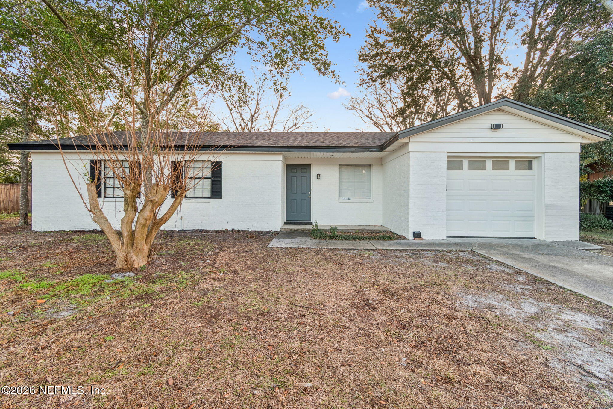 a view of a house with a yard and garage
