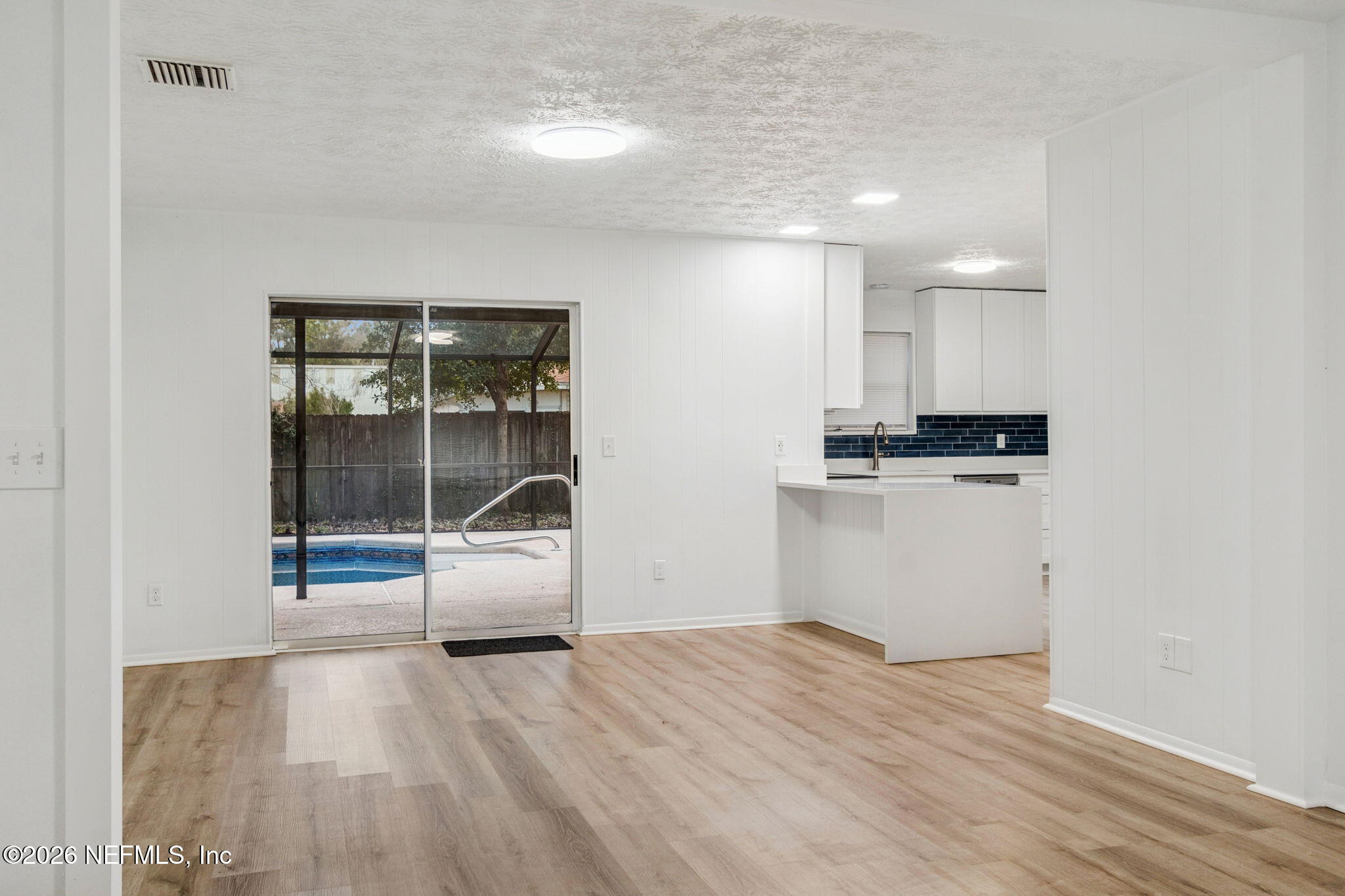 8234 Frost Street South Jacksonville, FL 32221 - Photo 14 of 65 a view of empty room with wooden floor and window