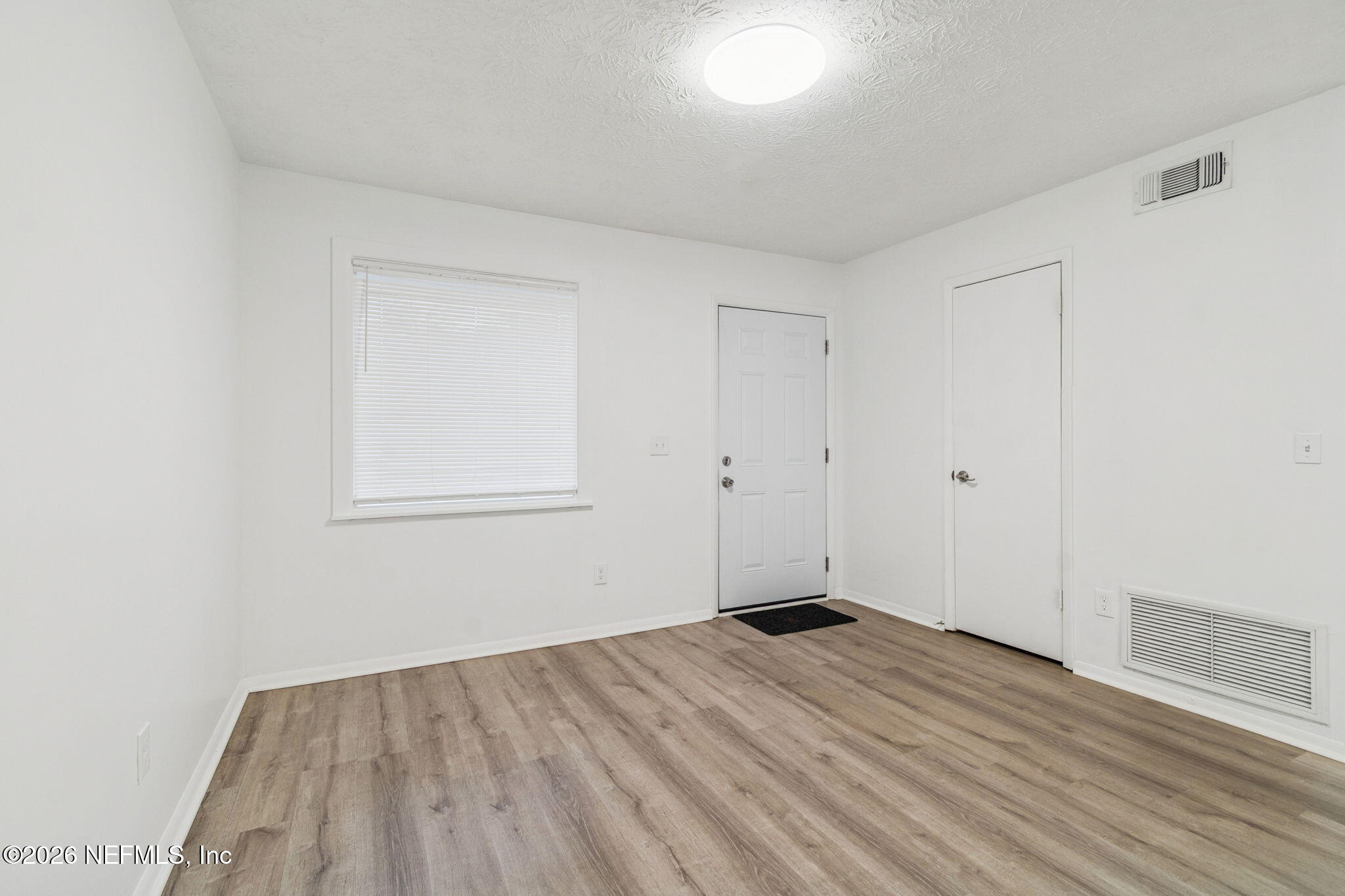 8234 Frost Street South Jacksonville, FL 32221 - Photo 17 of 65 a view of empty room with wooden floor