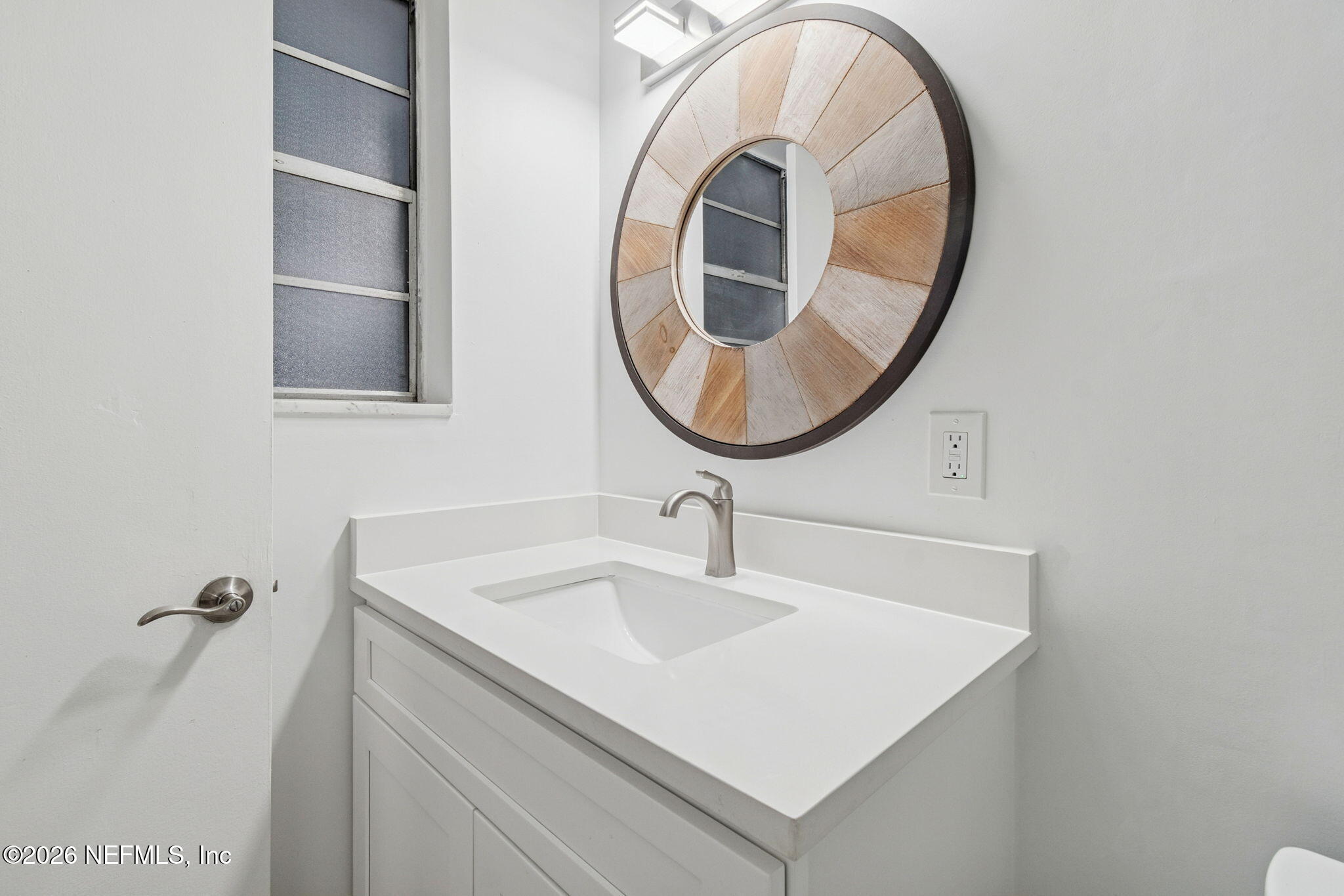 8234 Frost Street South Jacksonville, FL 32221 - Photo 34 of 65 a bathroom with a sink a vanity and a mirror