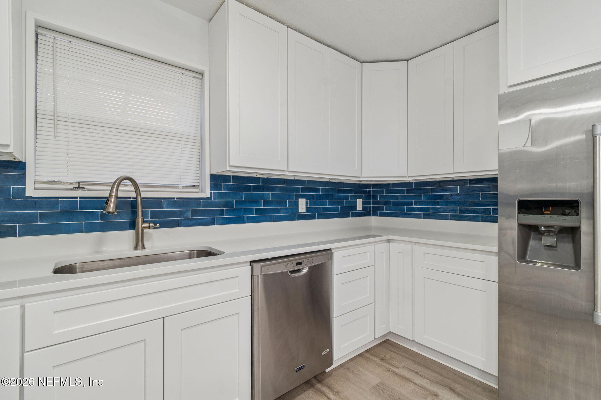 8234 Frost Street South Jacksonville, FL 32221 - Photo 37 of 65 a kitchen with white cabinets and a sink