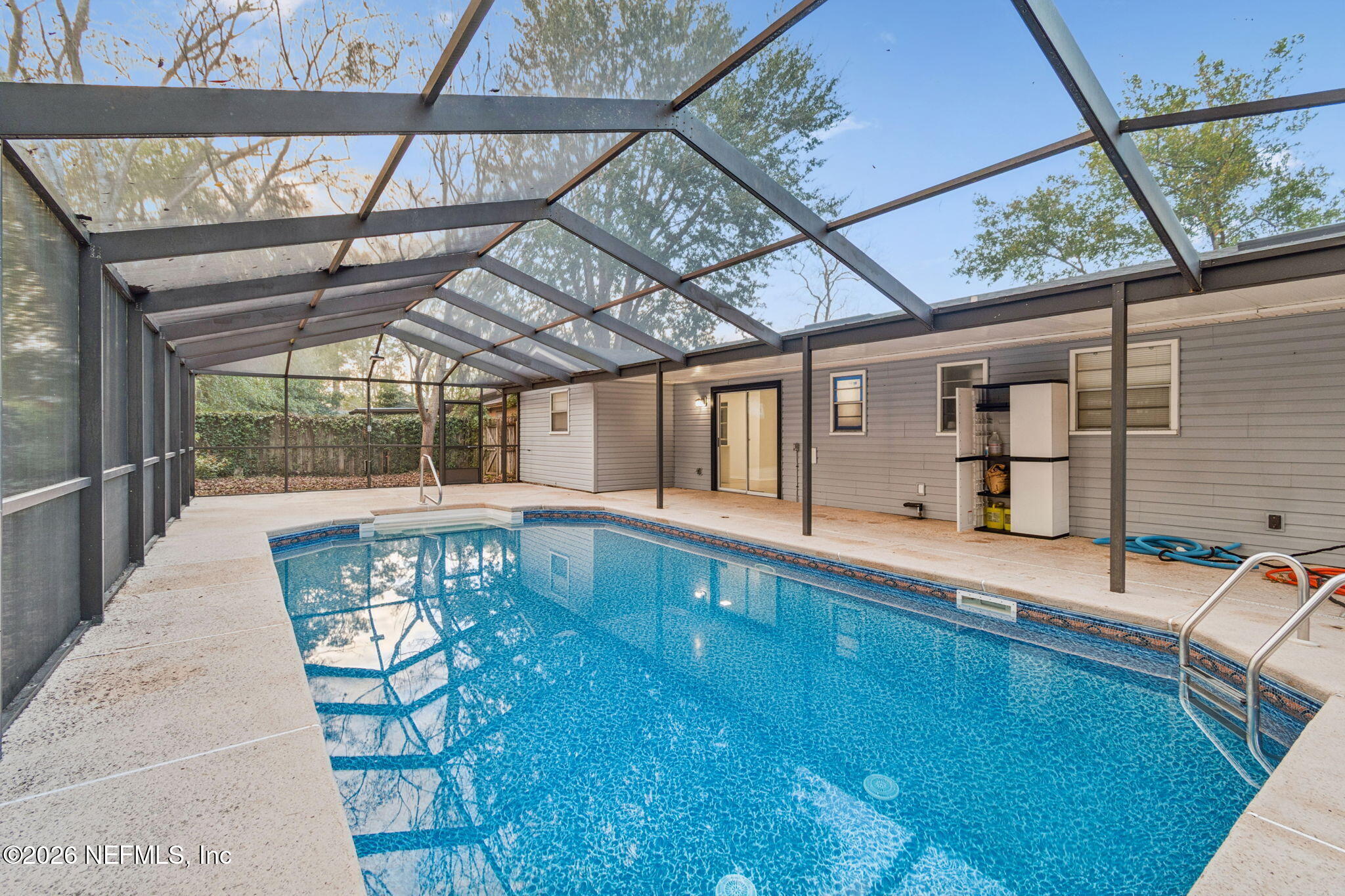 8234 Frost Street South Jacksonville, FL 32221 - Photo 51 of 65 a view of a living room with a floor to ceiling window and wooden floor